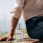 MYDOFT STORM PERFUME BOTTLE NEXT TO A MAN SITTING